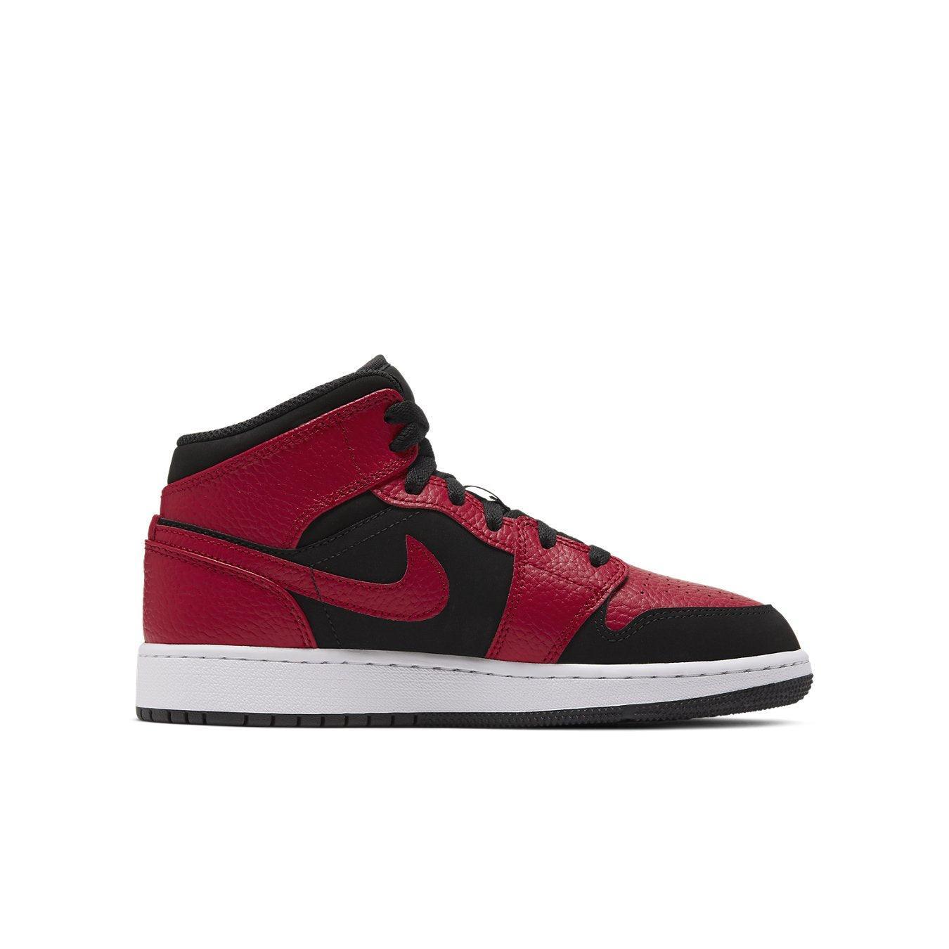 Air Jordan 1 Mid Reverse Bred (GS) in red and black leather with a white sole and iconic Swoosh design.