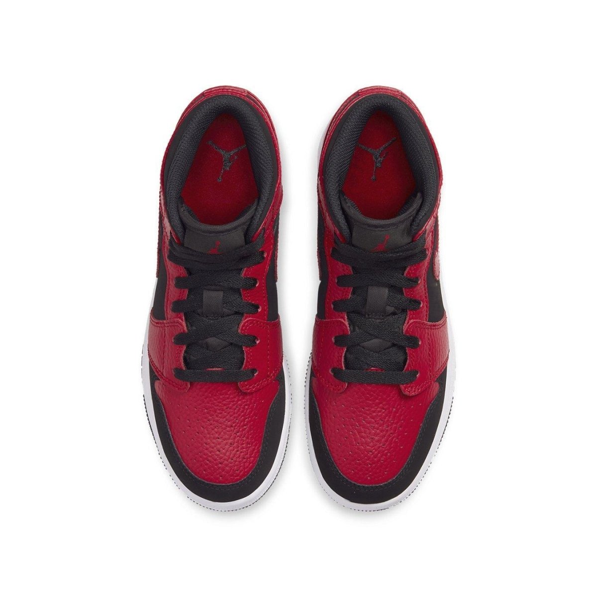 Top view of Air Jordan 1 Mid Reverse Bred GS sneakers featuring red and black leather. Classic design with iconic logo.