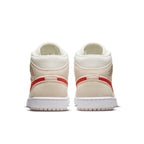 Back view of Air Jordan 1 Mid SE Corduroy Sail sneakers featuring corduroy upper and vibrant orange accents.