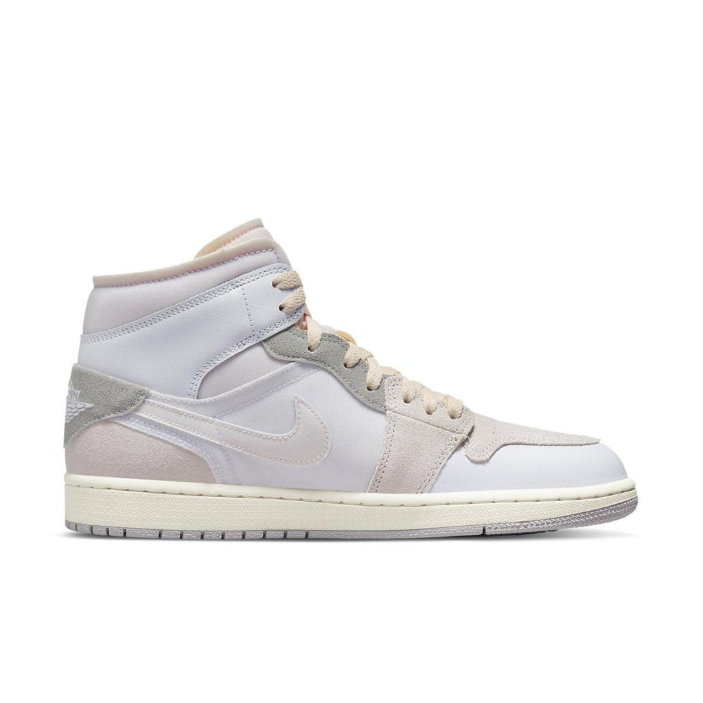 Jordan 1 Mid SE Craft Inside Out in white and grey, showcasing premium layered materials and playful color mix.