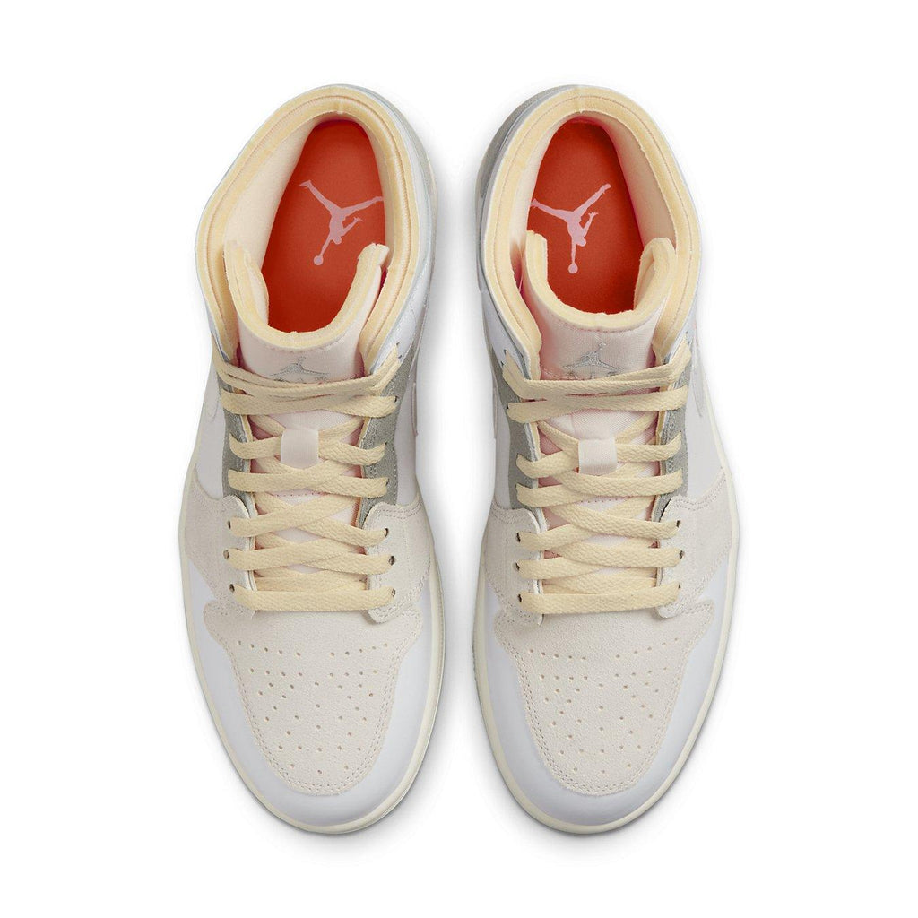 Jordan 1 Mid SE Craft Inside Out sneakers in white and grey with layered color panels and orange lining.