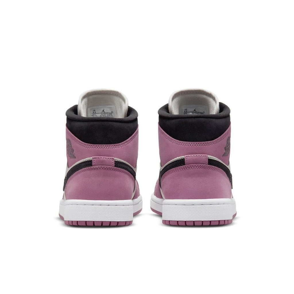 Back view of Air Jordan 1 Mid SE Light Mulberry sneakers in Berry Pink with black accents and white sole.