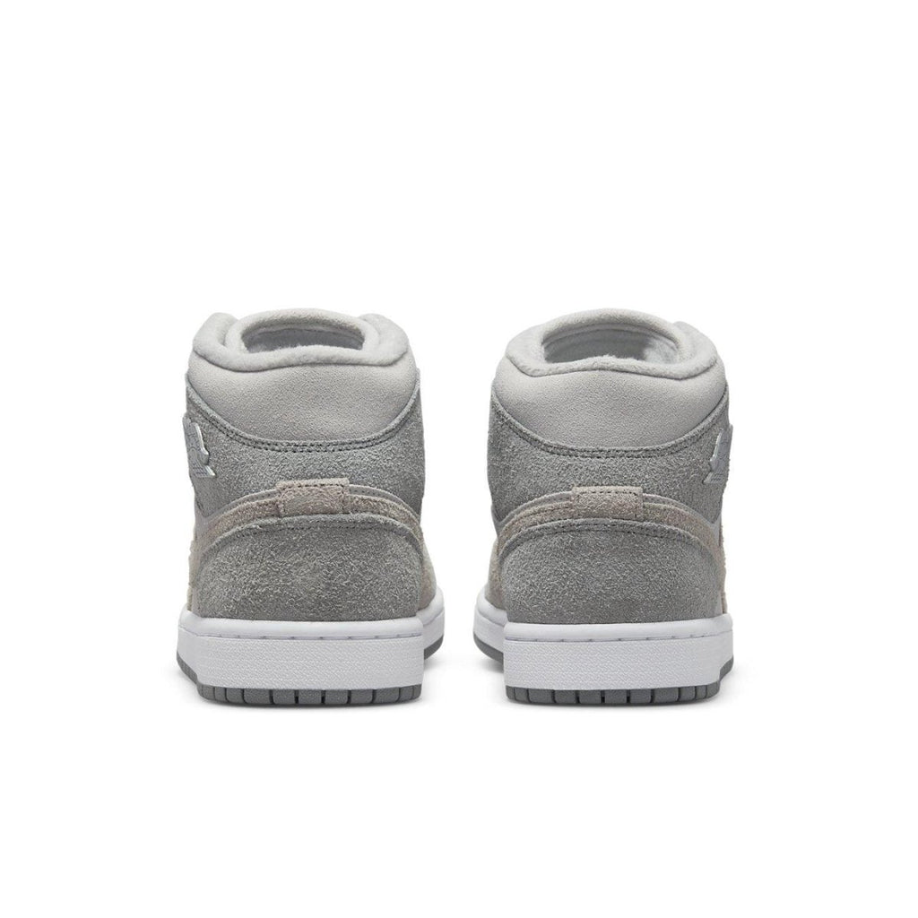 Rear view of Women's Jordan 1 Mid SE Particle Grey sneakers featuring textured grey suede and sleek design.