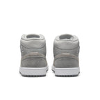Rear view of Women's Jordan 1 Mid SE Particle Grey sneakers featuring textured grey suede and sleek design.