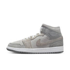Nike Air Jordan 1 Mid SE Particle Grey for women, featuring smooth synthetic leather and suede layers in shades of grey.