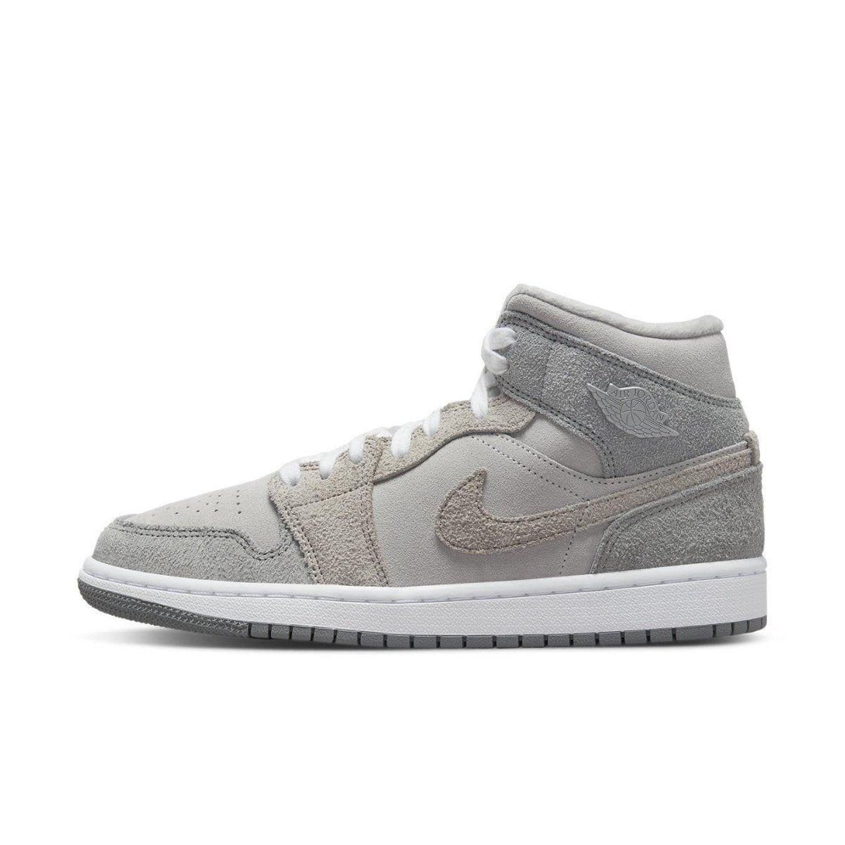 Nike Air Jordan 1 Mid SE Particle Grey for women, featuring smooth synthetic leather and suede layers in shades of grey.