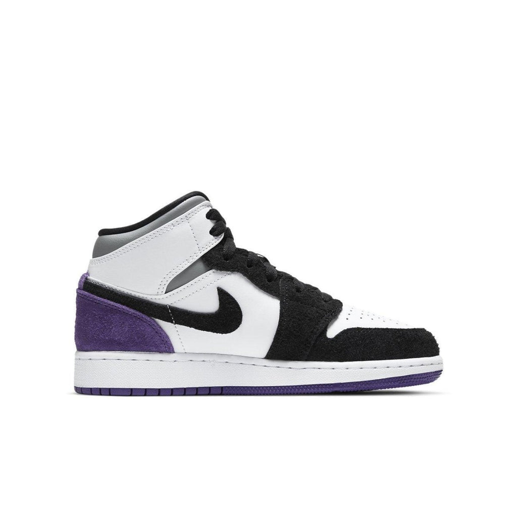 Jordan 1 Mid SE Purple (GS) featuring black, white, and purple suede design and high-top silhouette.