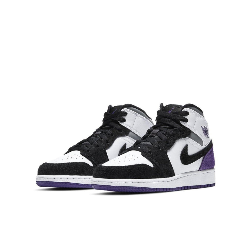 Air Jordan 1 Mid SE Purple GS sneakers featuring black, white, and purple colorway with suede detailing.