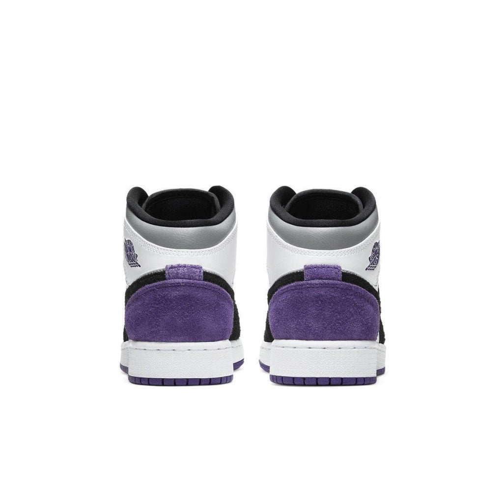 Back view of the Jordan 1 Mid SE Purple (GS) sneakers with suede details and classic color scheme.