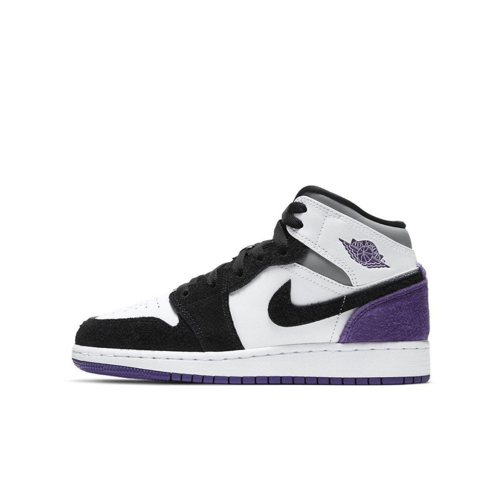 Jordan 1 Mid SE Purple GS sneaker in black, white, and purple suede, featuring classic basketball design.