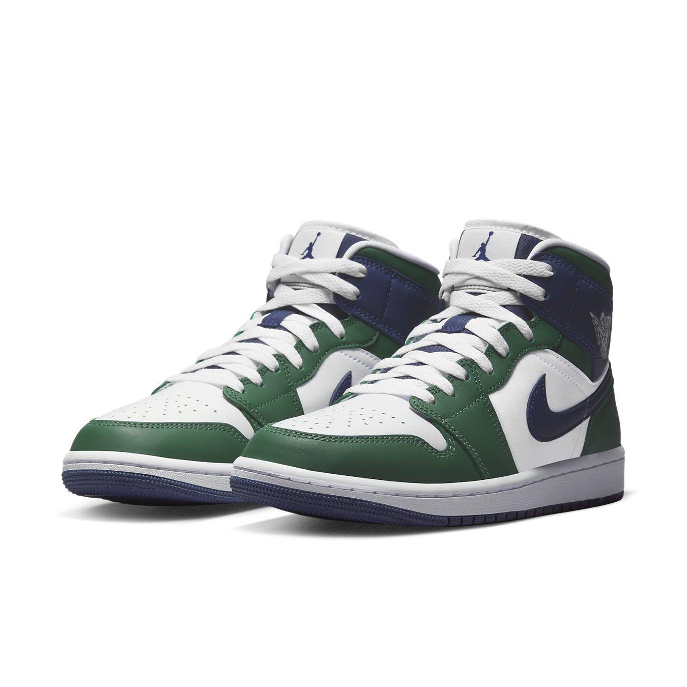 Jordan 1 Mid SE Seahawks (W) sneakers in white and green, featuring navy blue accents and Air Jordan branding.