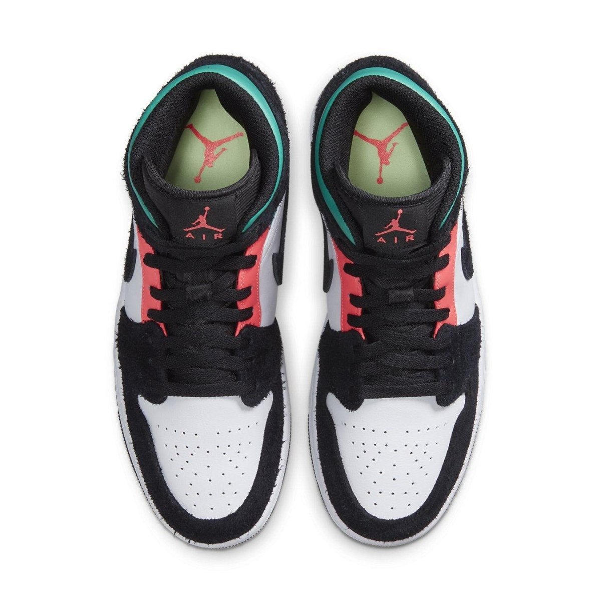 Top view of Jordan 1 Mid SE South Beach sneakers showcasing black suede, white leather, and pink-green accents.