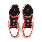 Top view of Air Jordan 1 Mid SE Turf Orange sneakers showcasing orange and white colorway with black laces.