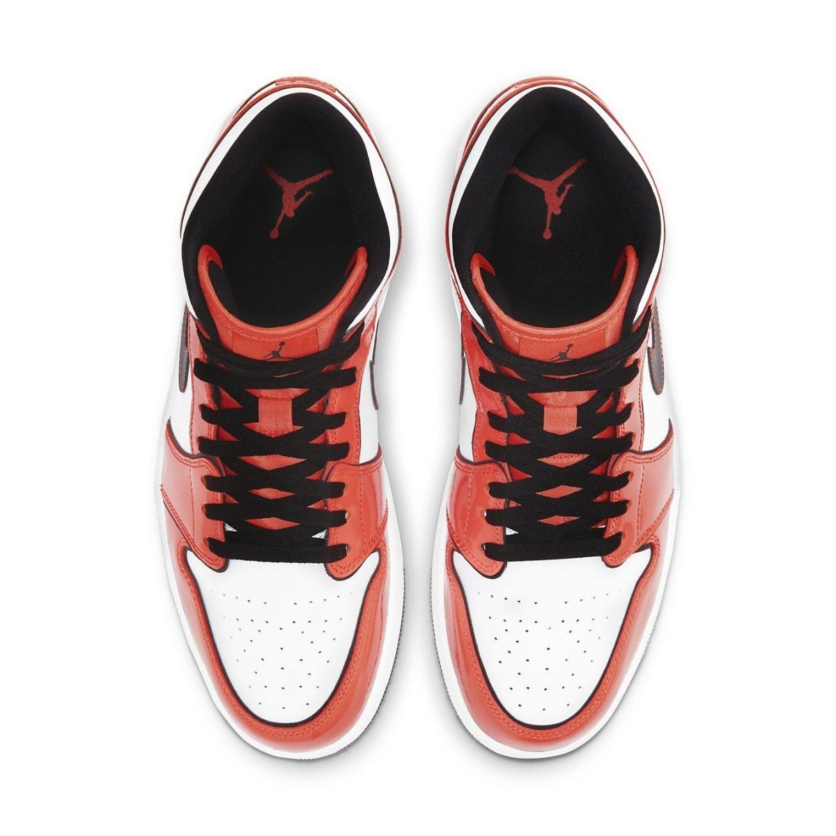 Top view of Air Jordan 1 Mid SE Turf Orange sneakers showcasing orange and white colorway with black laces.
