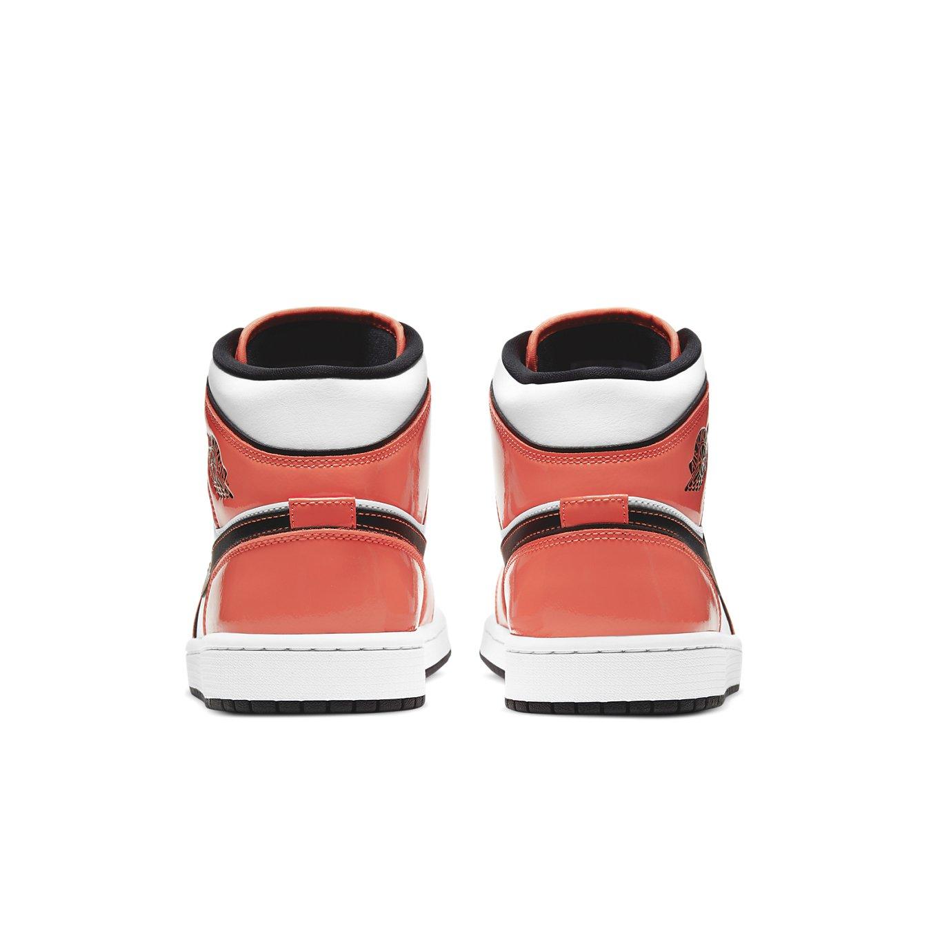 Rear view of the Air Jordan 1 Mid SE in Turf Orange, showcasing glossy leather and signature design elements.