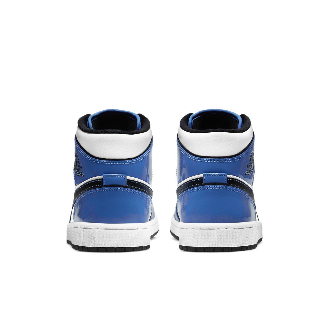 Jordan 1 Mid Signal Blue sneaker back view showcasing blue and white design with black accents.