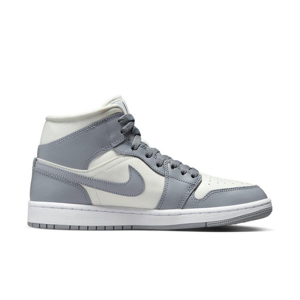 Jordan 1 Mid Stealth for women featuring a clean sail and grey colorway with classic white midsole.