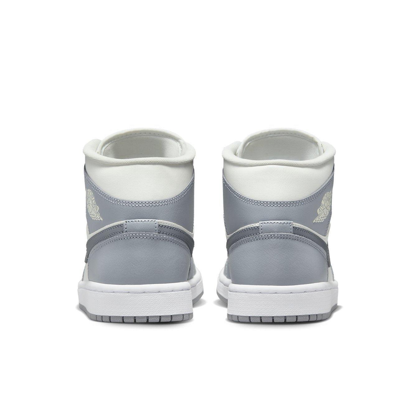 Rear view of Jordan 1 Mid Stealth (W) sneakers featuring a clean gray and white design.