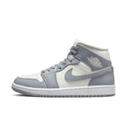 Jordan 1 Mid Stealth (W) in Sail and Stealth with gray overlays and white midsole, perfect for a minimalist look.