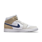 Jordan 1 Mid Tan Suede sneakers in white leather, dark blue Swoosh, and light brown suede accents.