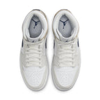 Air Jordan 1 Mid Tan Suede top view, featuring white leather, dark blue Swoosh, and suede overlays.