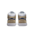 Back view of Jordan 1 Mid Tan Suede sneakers showcasing tan suede and dark blue accents on a white sole.