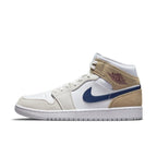 Air Jordan 1 Mid Tan Suede featuring white leather upper and tan suede overlays with dark blue Swoosh and red Wings logo.