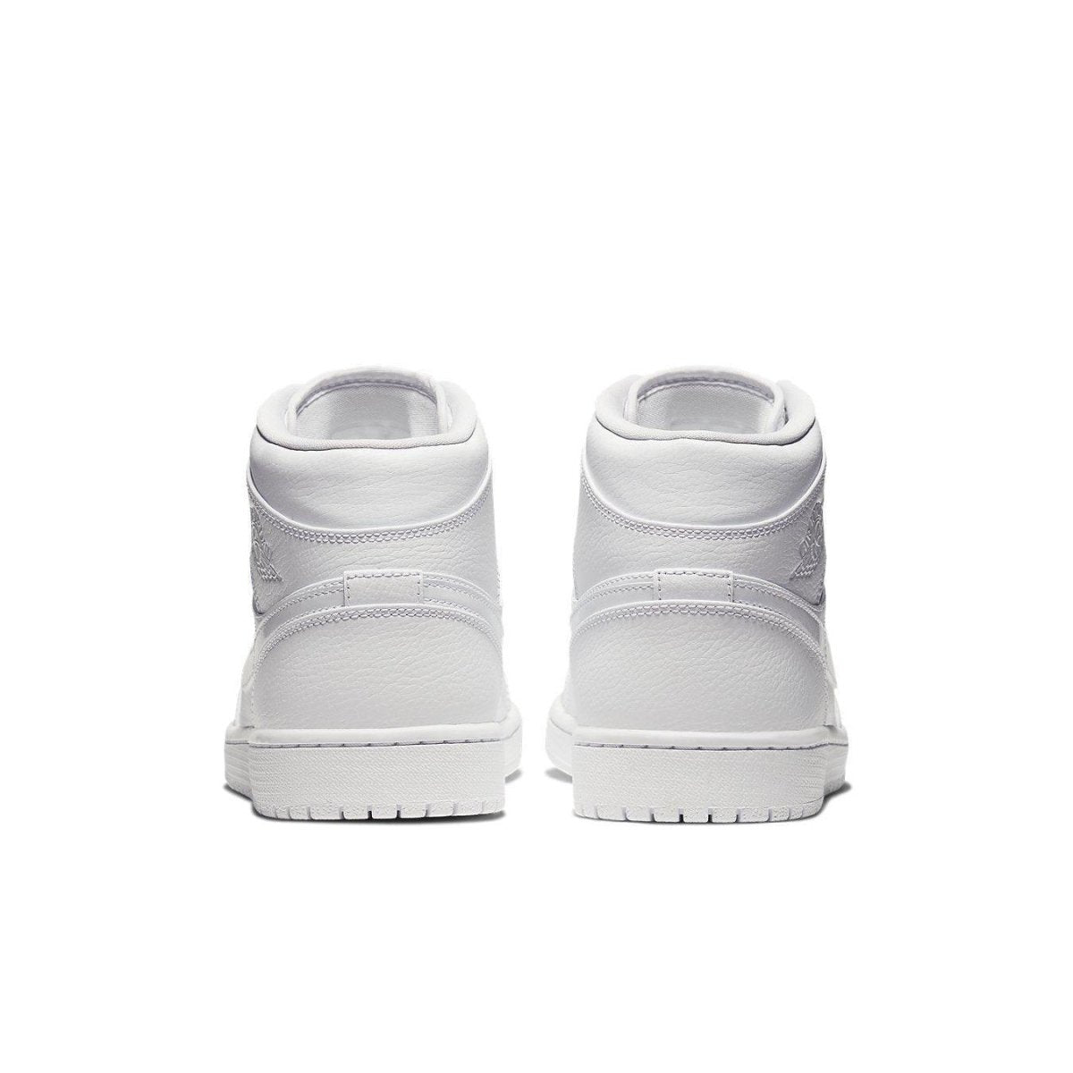 Jordan 1 Mid Triple White (2020) rear view showcasing all-white design and silver 'Wings' logo details.