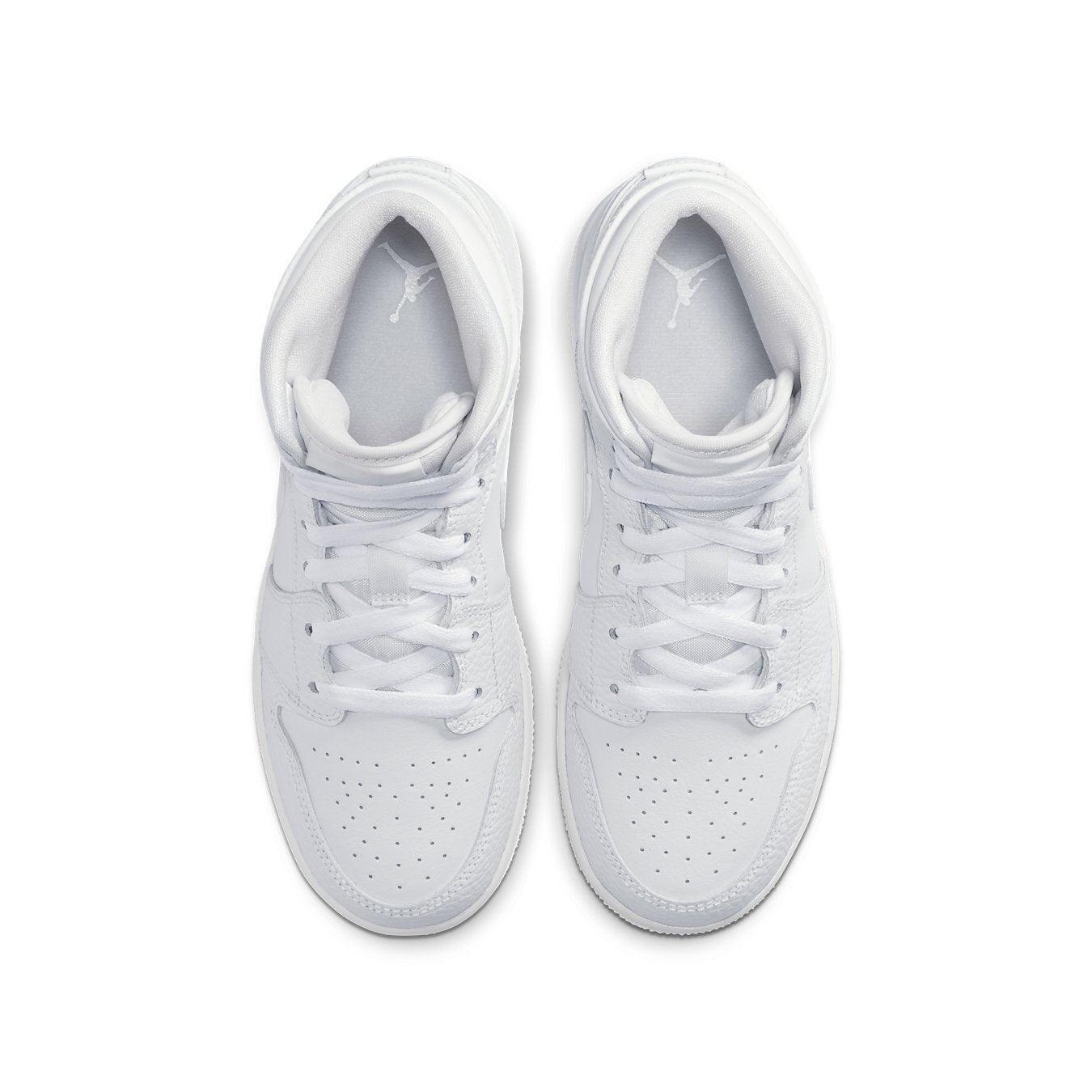 Top view of Air Jordan 1 Mid Triple White GS sneakers, featuring a clean white leather upper and subtle perforated details.