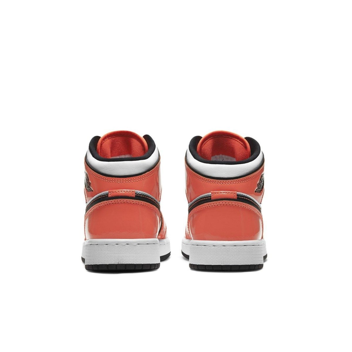 Rear view of Air Jordan 1 Mid Turf Orange GS sneakers showcasing glossy orange leather details.