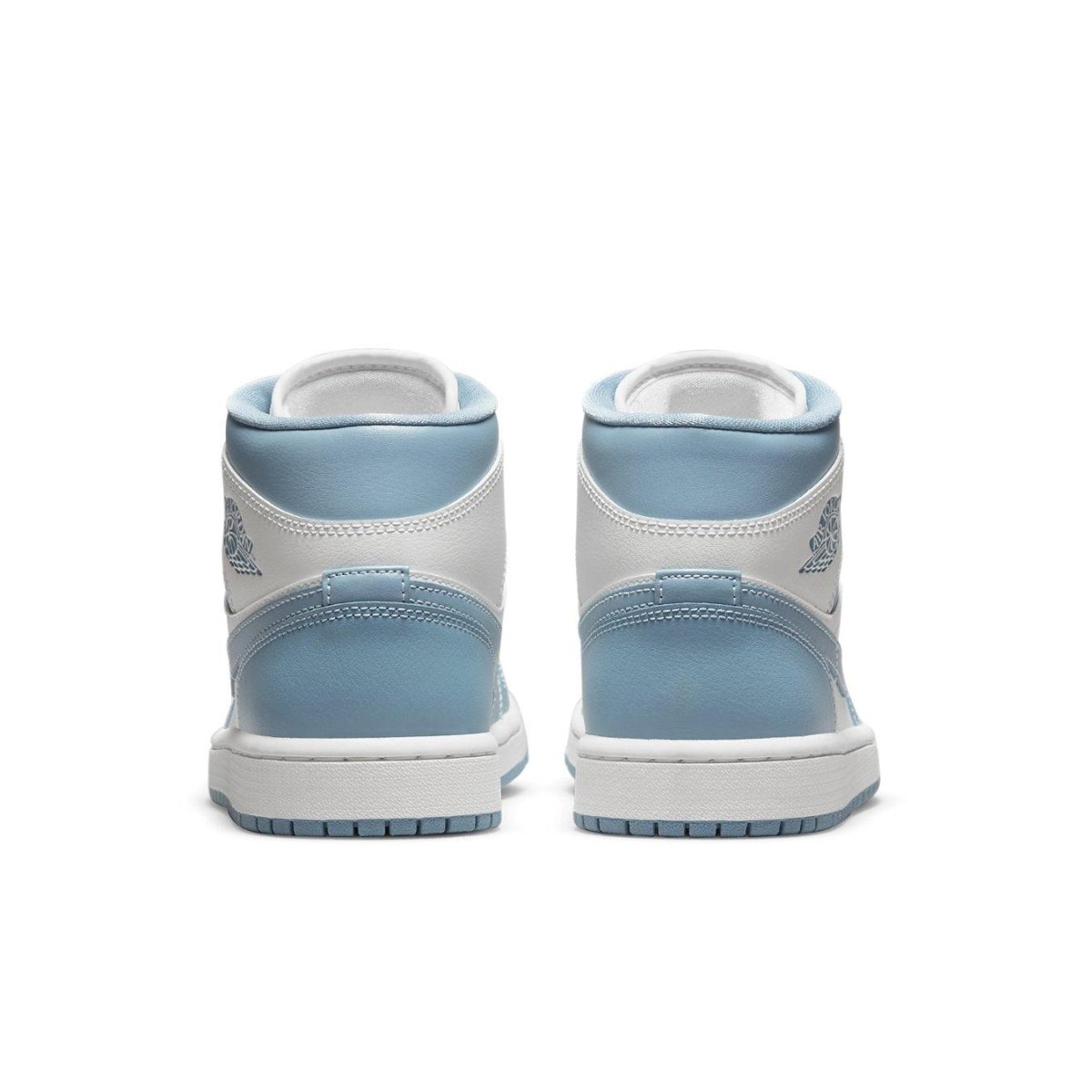 Rear view of women's Air Jordan 1 Mid UNC 2022 sneakers, featuring a white and University Blue color scheme.