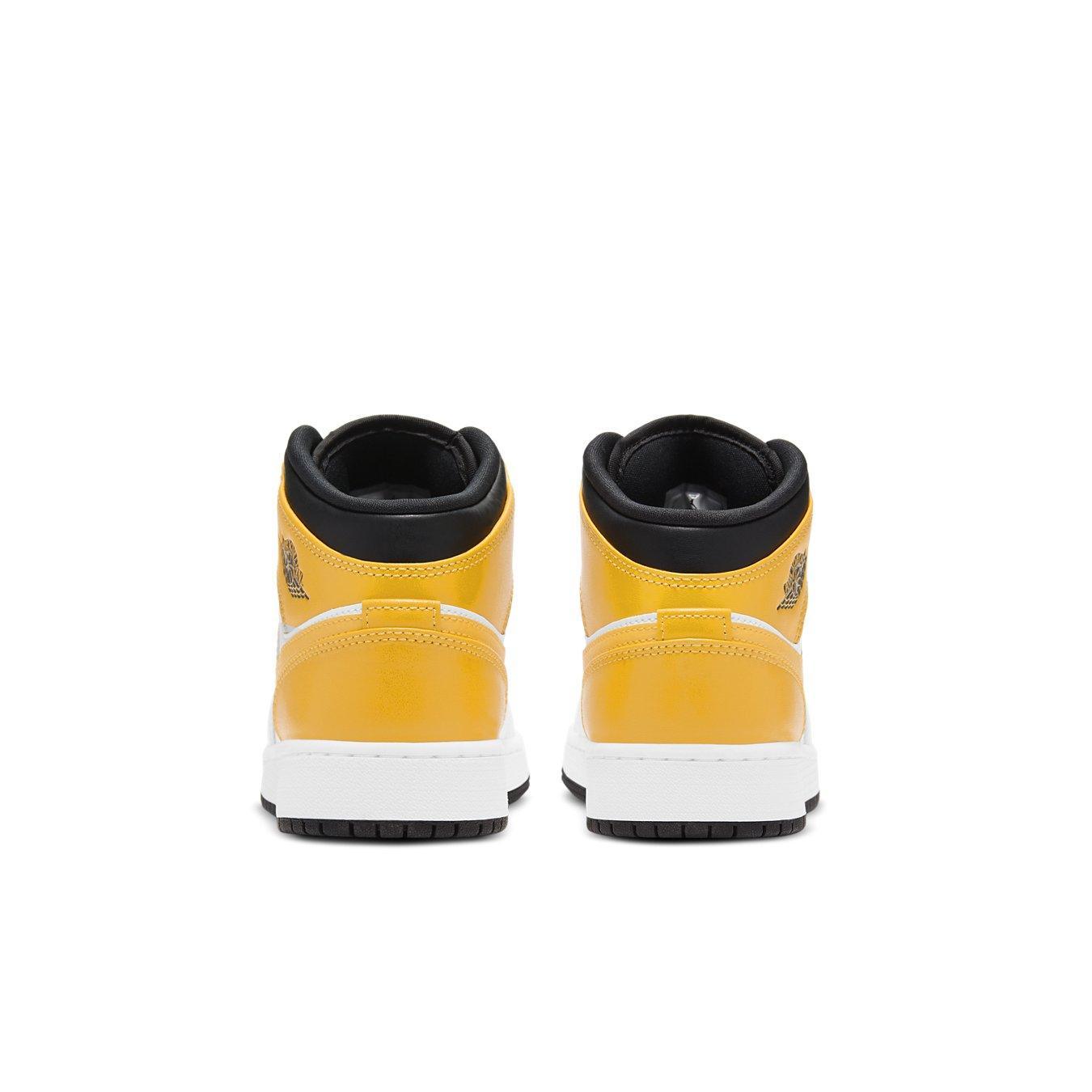 Back view of Jordan 1 Mid University Gold (GS) sneakers showcasing vibrant yellow color and iconic Wings logo.