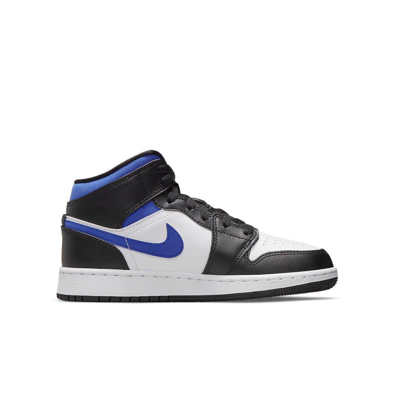 Jordan 1 Mid GS sneakers in white, black, and racer blue colorway, designed for big kids.
