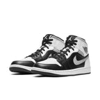 Air Jordan 1 Mid White Shadow in black and white leather with Nike swoosh, featuring black laces and classic design.