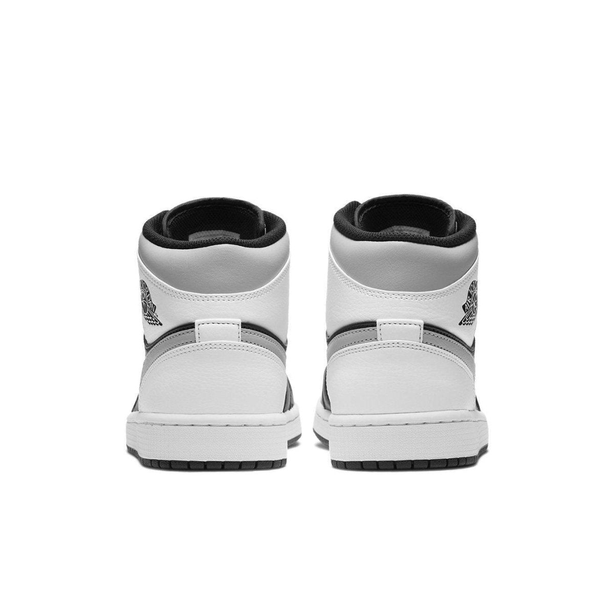 Back view of Air Jordan 1 Mid White Shadow sneakers featuring black and white design and iconic logo.