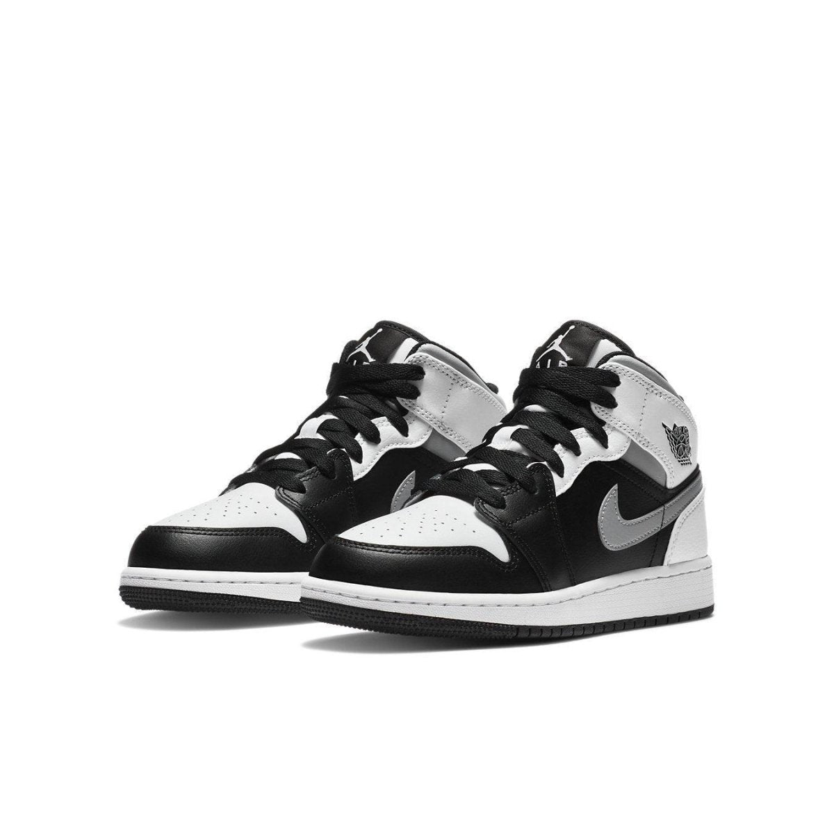 Air Jordan 1 Mid White Shadow (GS) featuring black and white leather with Nike swoosh and wings logo.