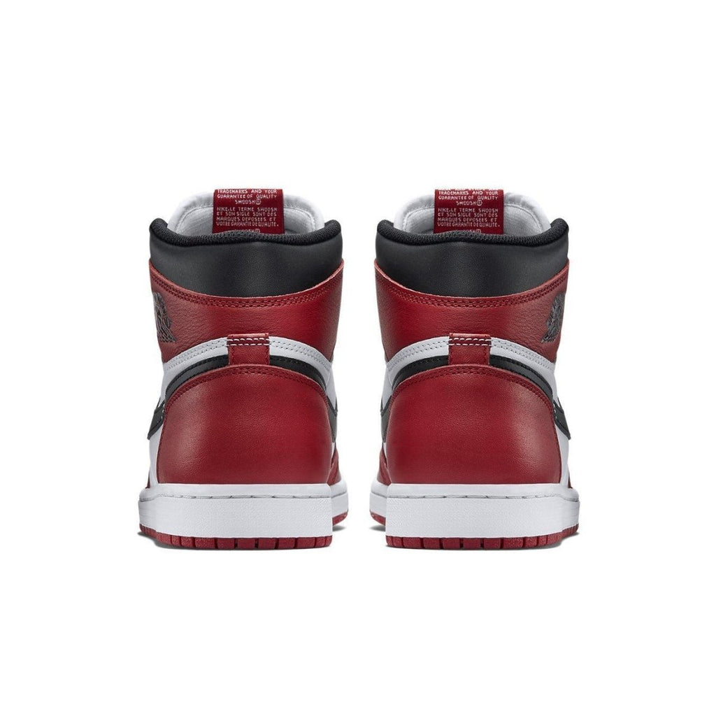 Back view of Air Jordan 1 Retro Chicago 2015 sneakers highlighting red, white, and black colorway.