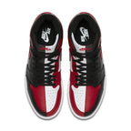 Top view of Air Jordan 1 Retro High Homage to Home in black and red leather, featuring a vintage Chicago Bulls colorway.