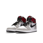 Jordan 1 Retro High Light Smoke Grey sneakers featuring gray suede, white leather, and Varsity Red accents.