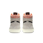 Rear view of Jordan 1 Retro High Neutral Grey Hyper Crimson with grey suede and orange accents.