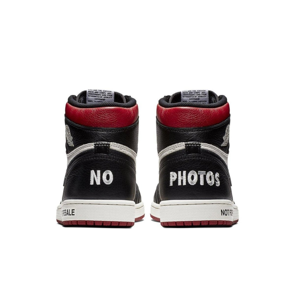 Back view of Air Jordan 1 Retro High 'Not for Resale' in Varsity Red, featuring 'NO PHOTOS' on the heels.