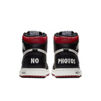 Back view of Air Jordan 1 Retro High 'Not for Resale' in Varsity Red, featuring 'NO PHOTOS' on the heels.