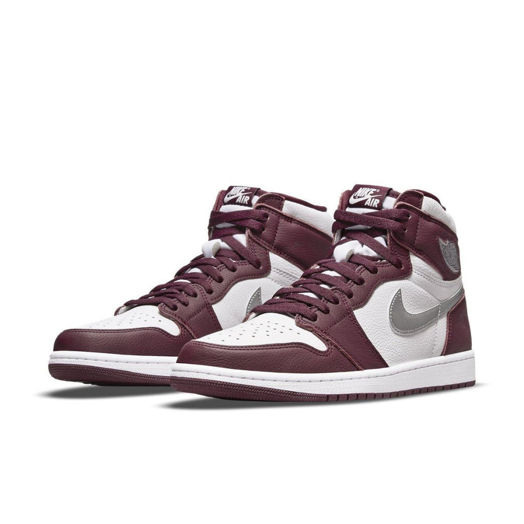 Air Jordan 1 Retro High OG Bordeaux sneaker in maroon and white with silver Swoosh detailing.