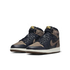 Jordan 1 Retro High OG Palomino GS in black and brown leather with yellow Nike Air logo on tongue.