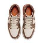 Top view of Women's Air Jordan 1 Retro High OG 'Dusted Clay' sneakers in tan and brown suede with orange accents.