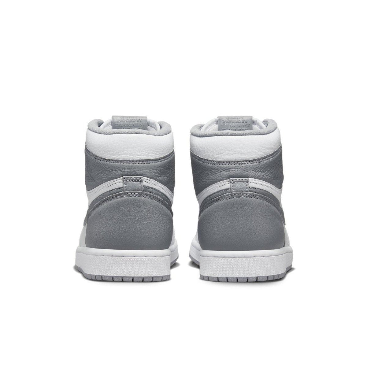 Back view of Jordan 1 Retro High OG Stealth sneakers showcasing sleek grey and white design.