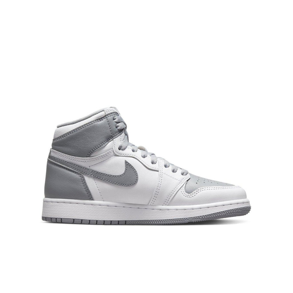 Air Jordan 1 Retro High OG Stealth (GS) sneaker in white and grey leather, featuring iconic design and Wings logo.