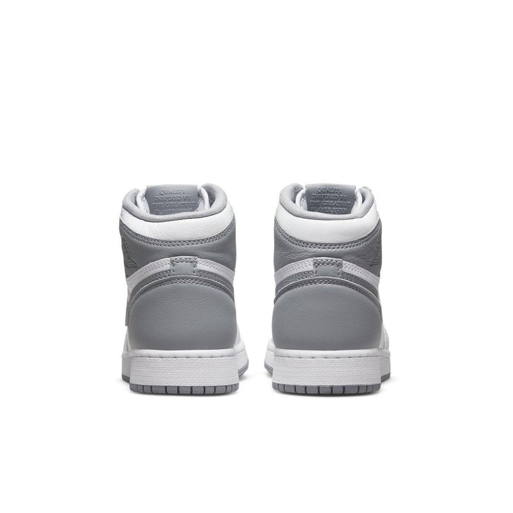 Rear view of Air Jordan 1 Retro High OG Stealth (GS) sneakers showcasing grey and white design.