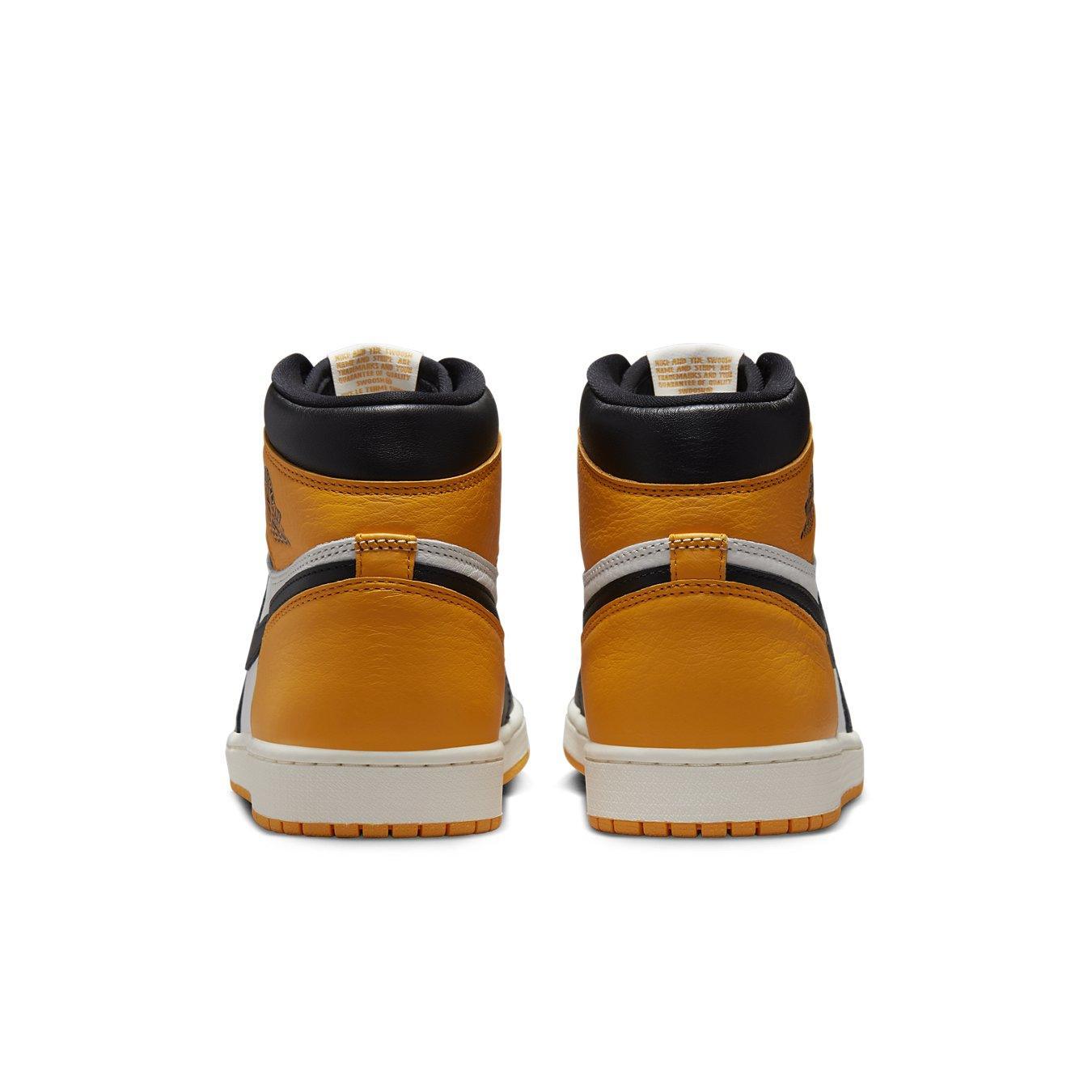 Rear view of Air Jordan 1 Retro High OG Taxi sneakers showcasing yellow leather and black details.