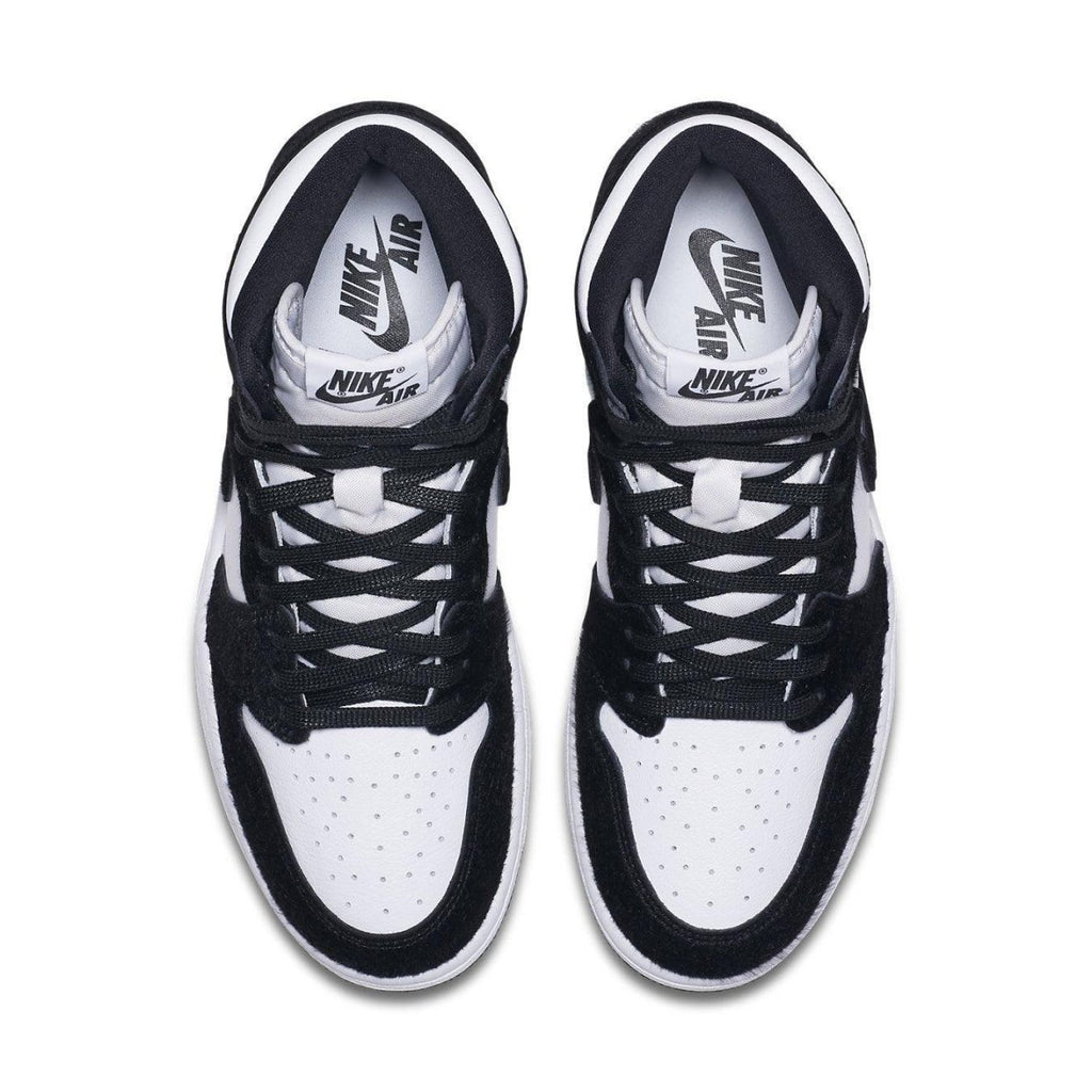 Top view of Jordan 1 Retro High Twist women's sneakers in black and white with smooth leather and suede details.
